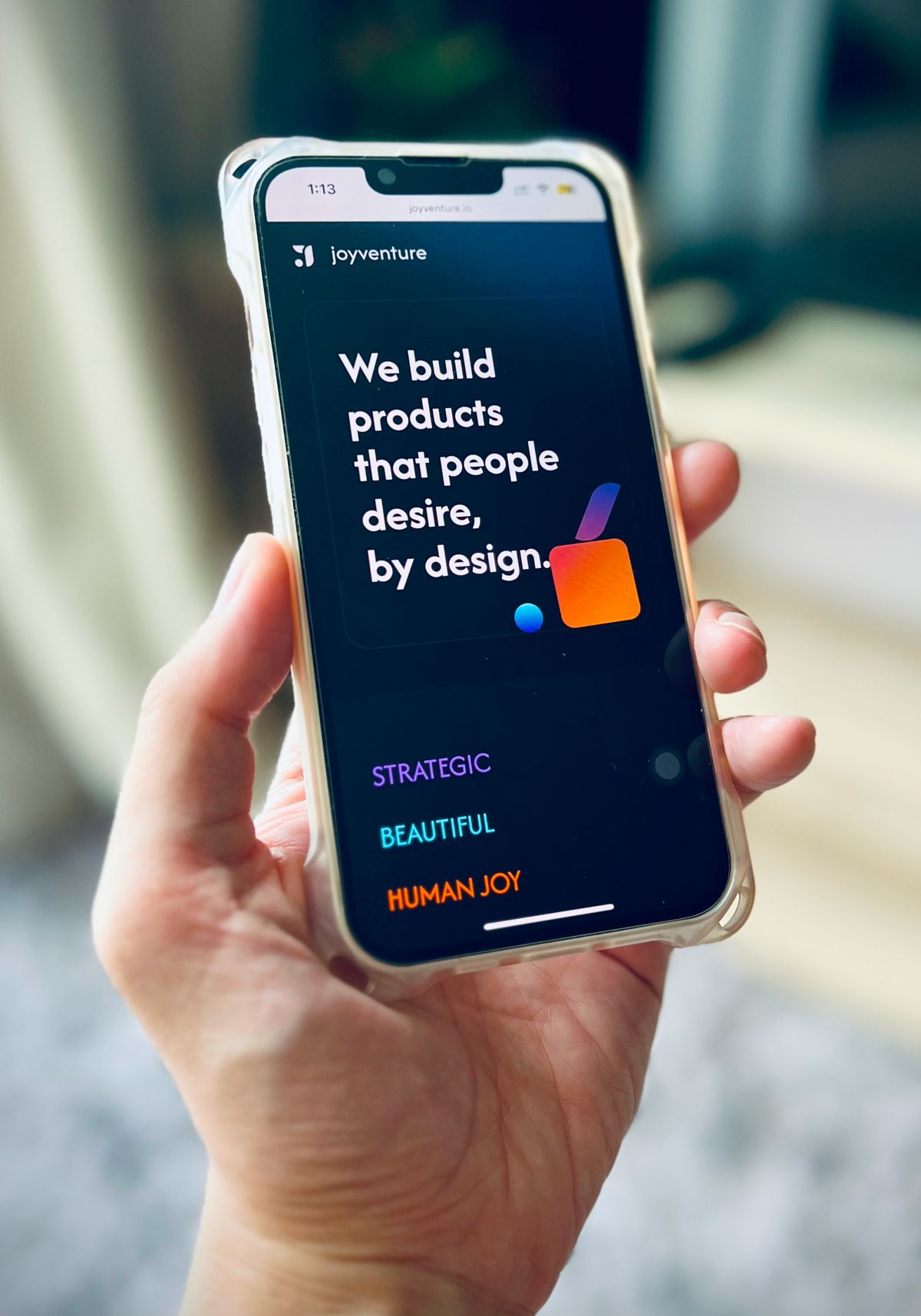 Phone showing Joyventure: we build products that people desire, by design