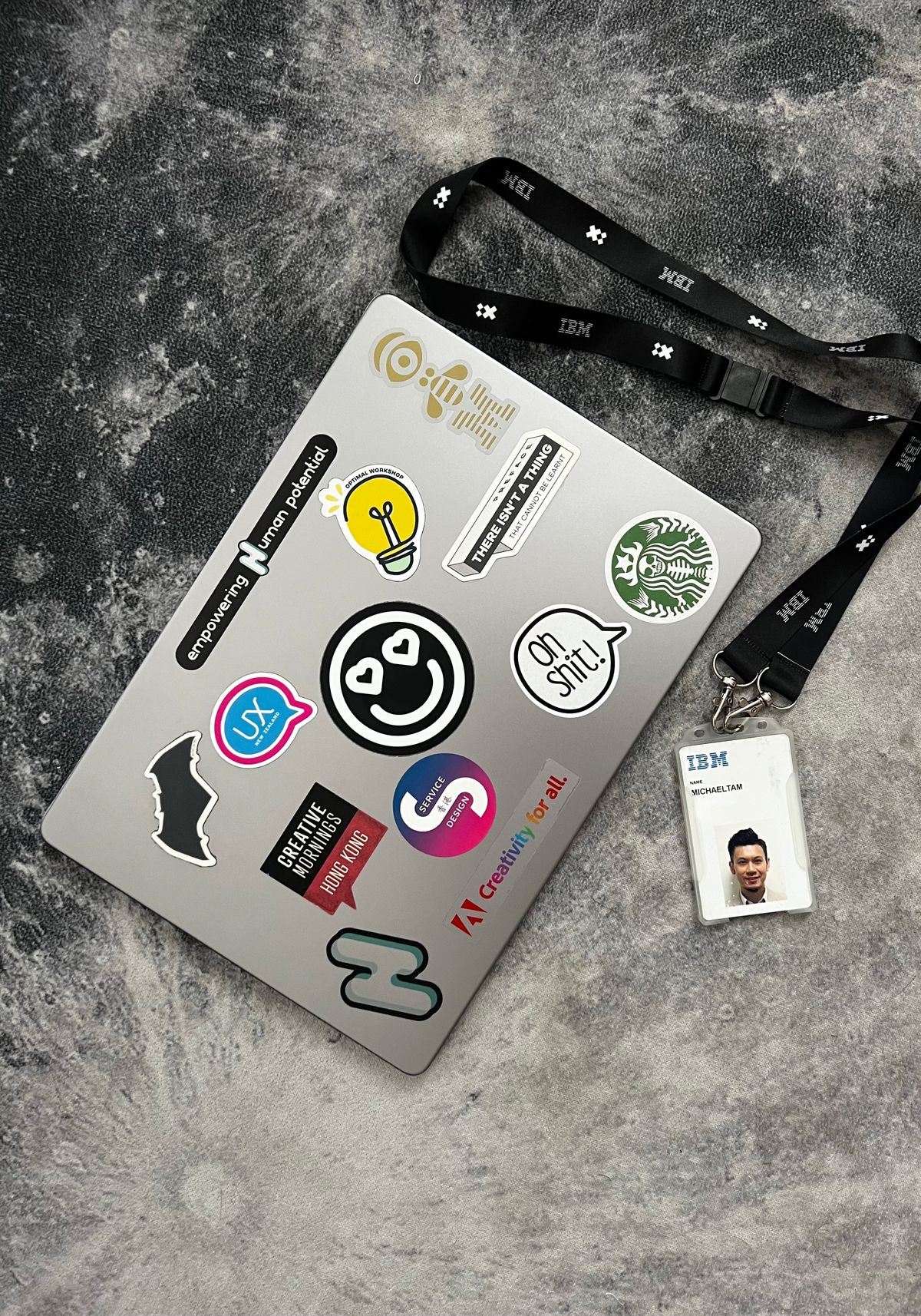 IBM laptop covered in design stickers with an IBM badge