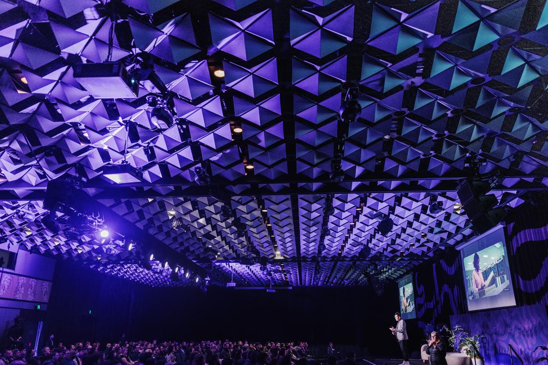 Michael Tam delivering a keynote on stage