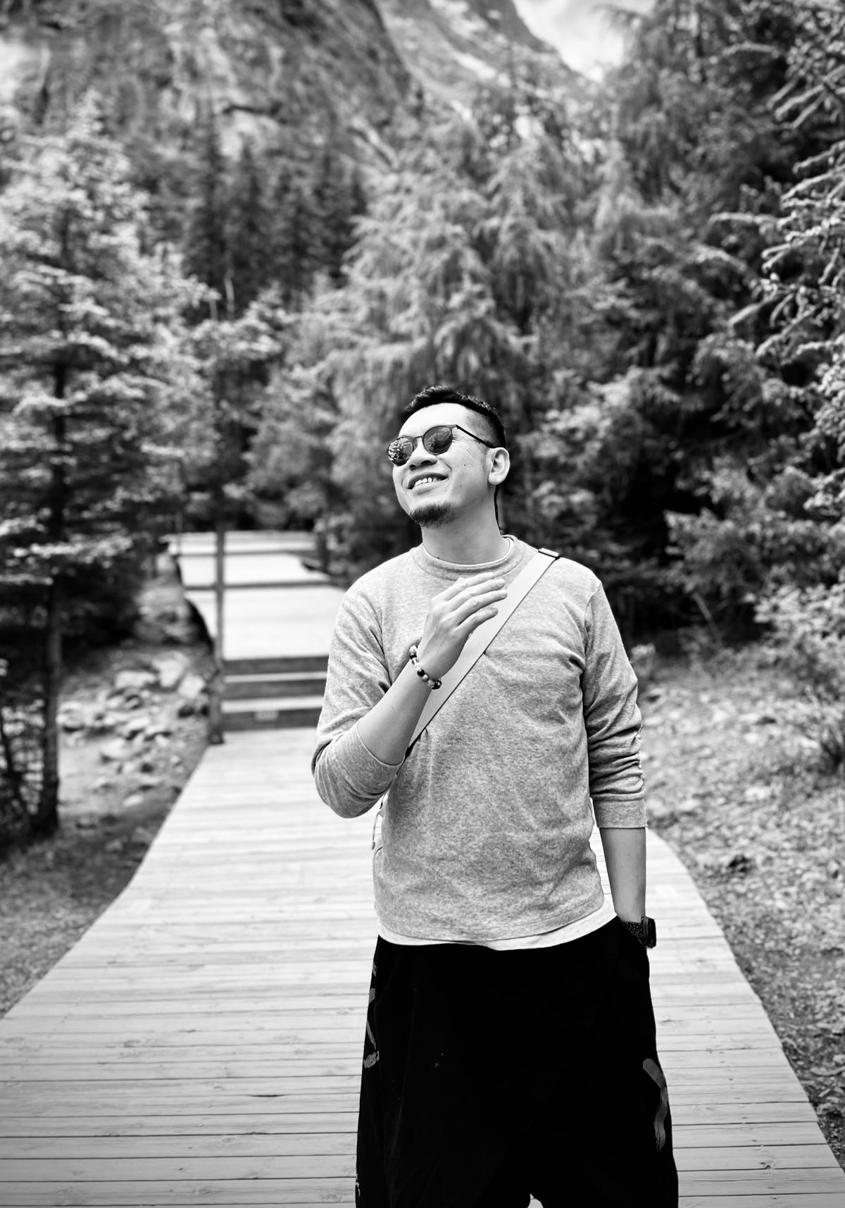 Michael Tam, black and white portrait on a mountain boardwalk